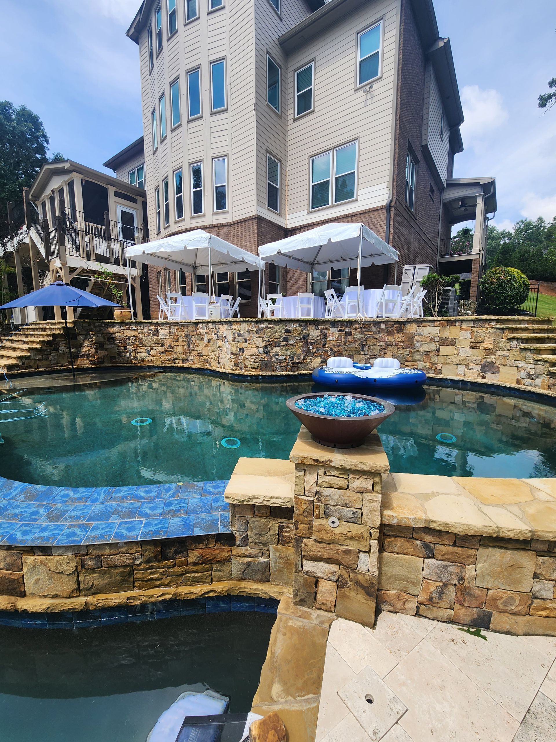 A large house with a swimming pool in front of it.