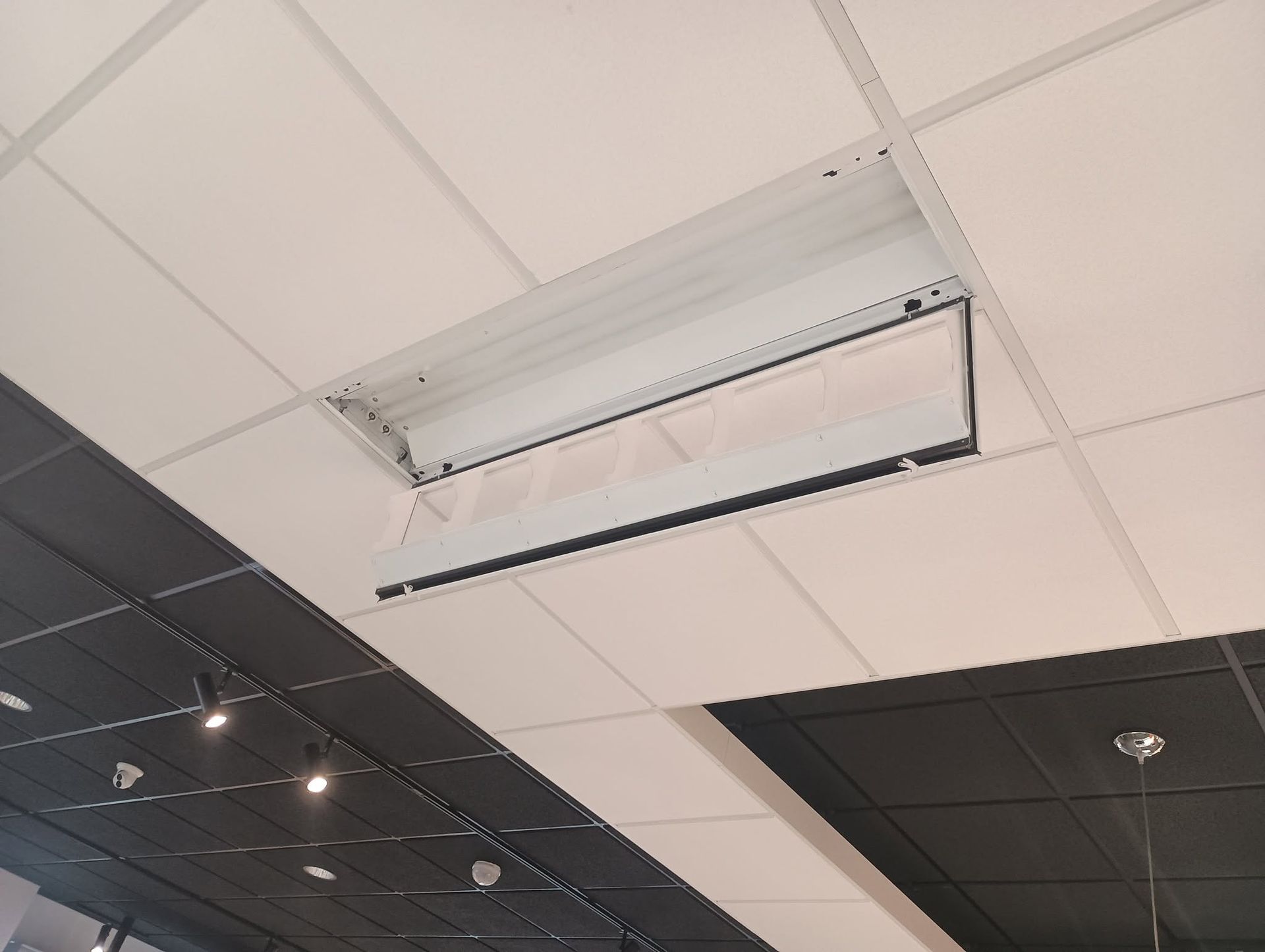 Ceiling vent panel missing, showing an open HVAC opening in a drop ceiling.