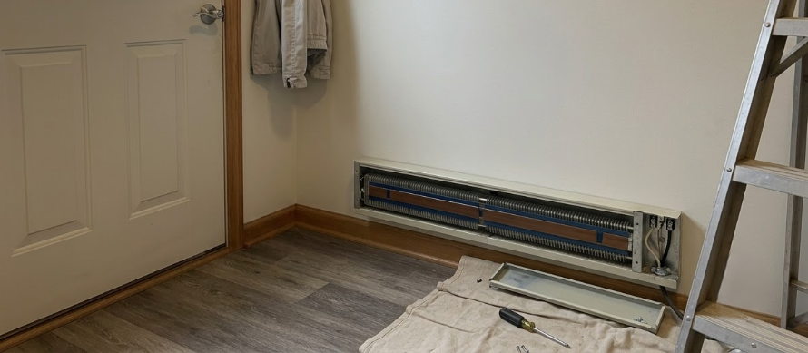 Wooden dock with electrical conduit and junction boxes extending over calm water
