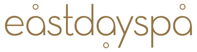 East Day Spa logo in gold text with small circular accents on a white background