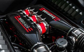 A close up of the engine of a ferrari car.