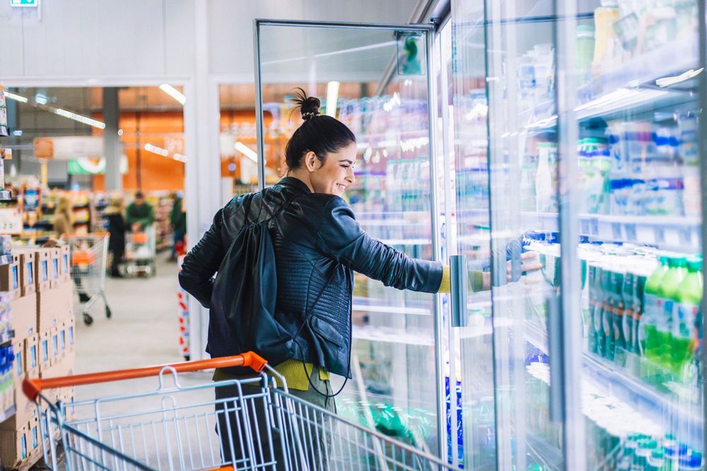 Young Woman Shopping In Supermarket — Bradenton, FL — Comfort Kings Heating Cooling & Refrigeration Young Woman Shopping In Supermarket — Bradenton, FL — Comfort Kings Heating Cooling & Refrigeration