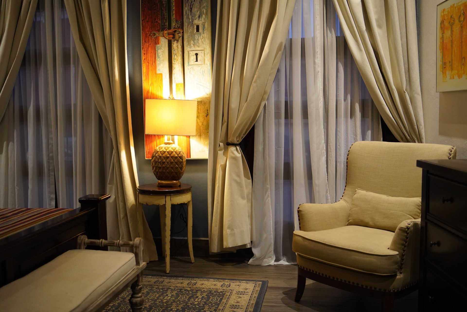 Una sala de estar con una silla y una lámpara.