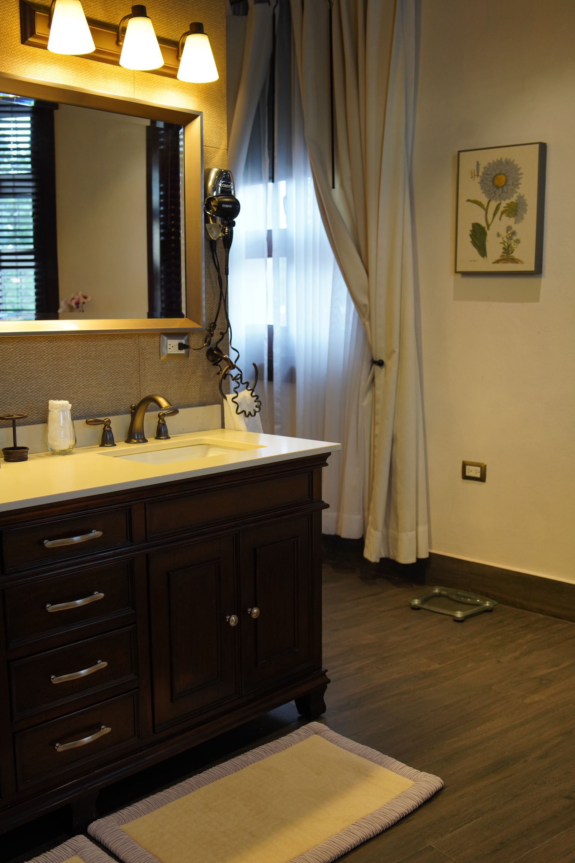A bathroom with a sink a mirror and a scale