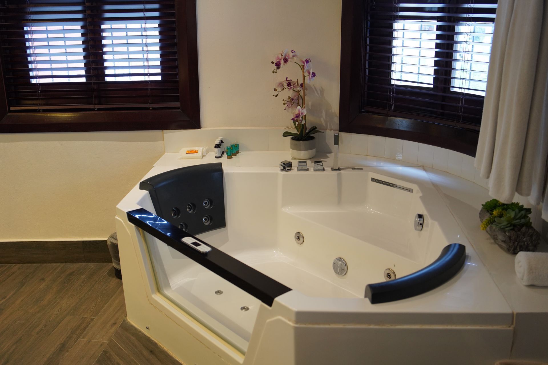 A large jacuzzi tub in a bathroom next to a window