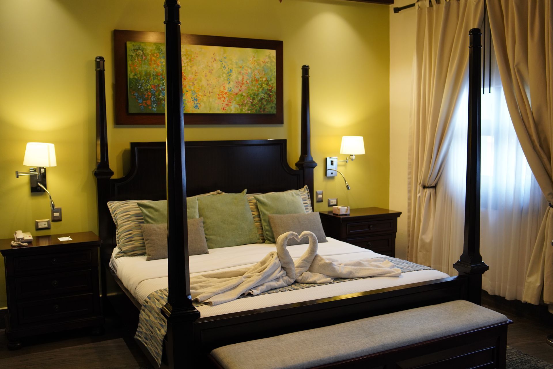 A bedroom with a four poster bed and a window