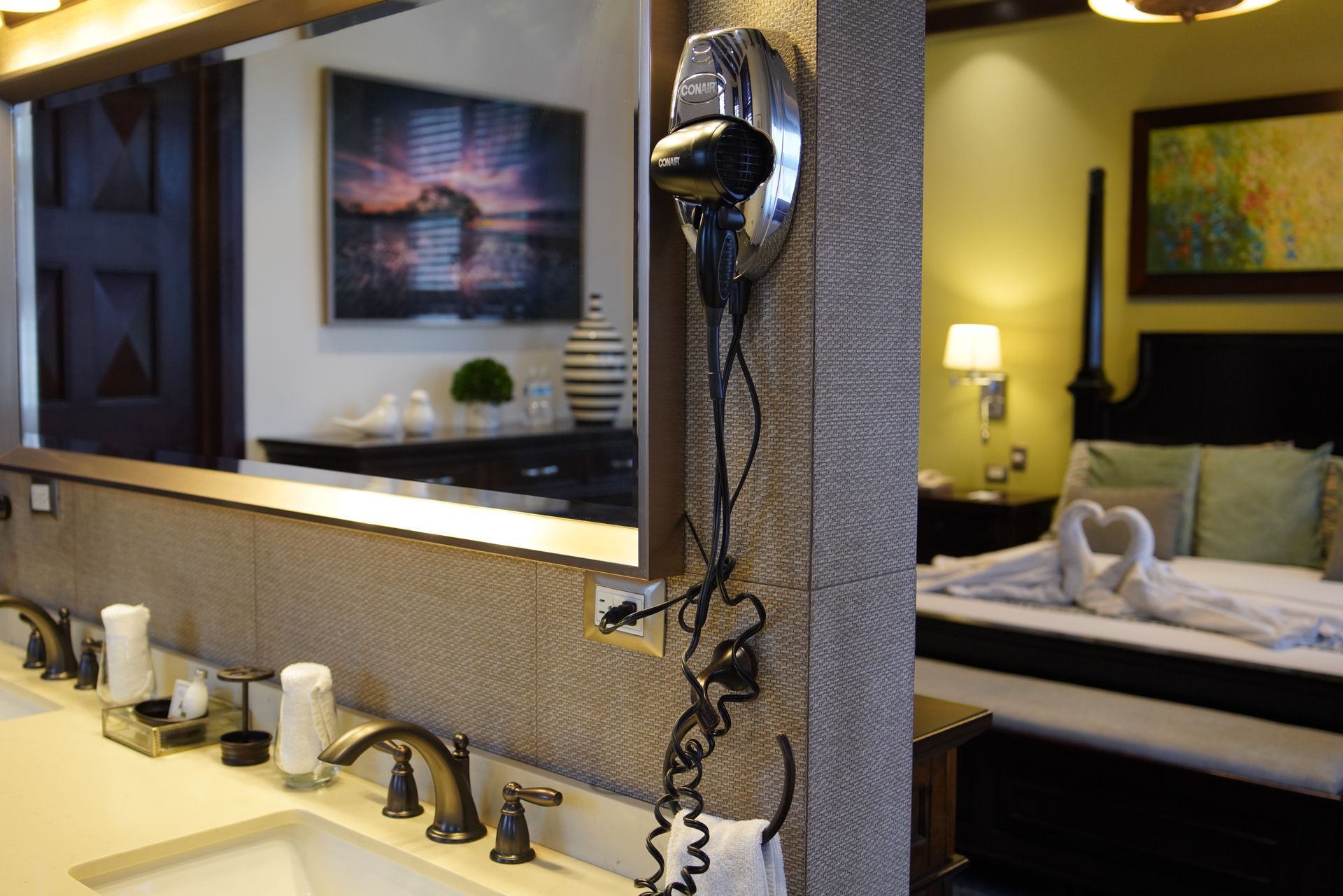 A bathroom with a large mirror and a hair dryer