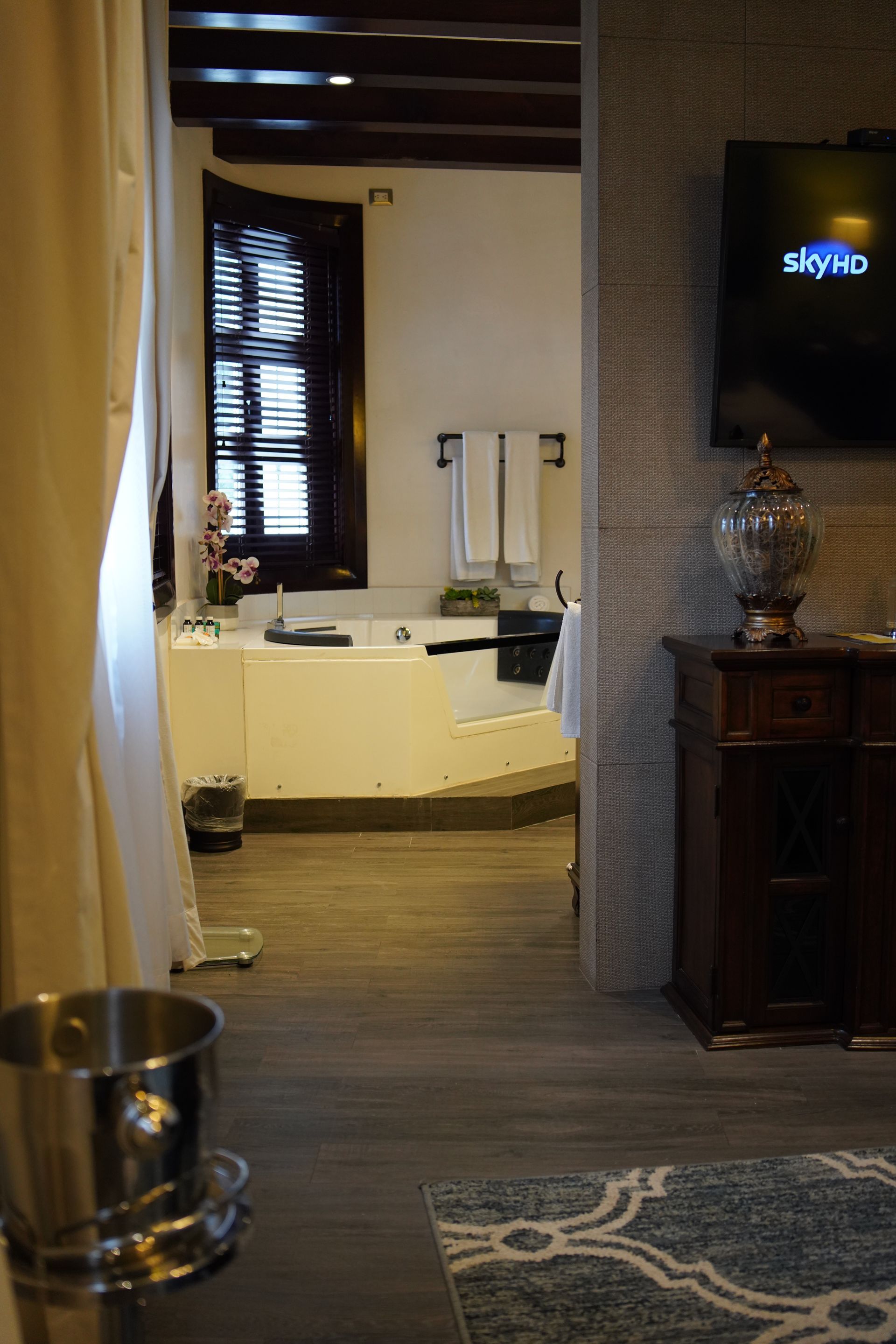 A bathroom with a tub and a sky tv on the wall