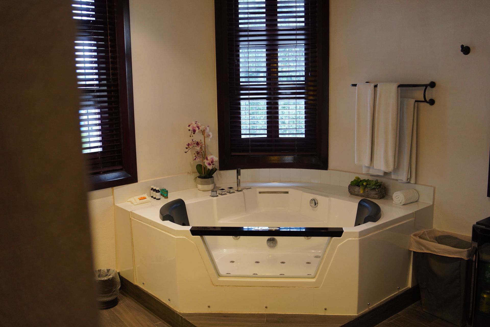 A bathroom with a jacuzzi tub and a window.