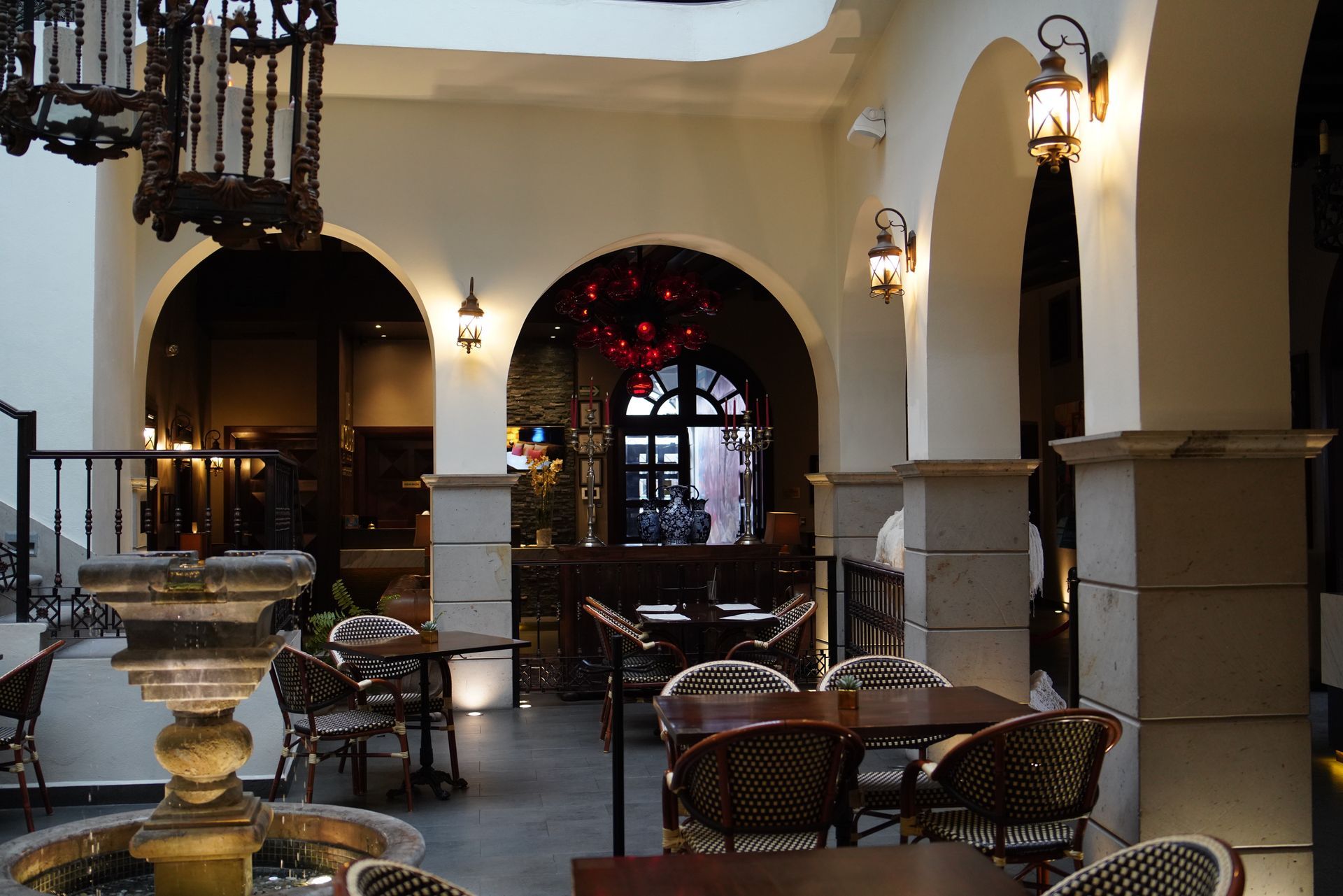 A restaurant with tables and chairs and a fountain