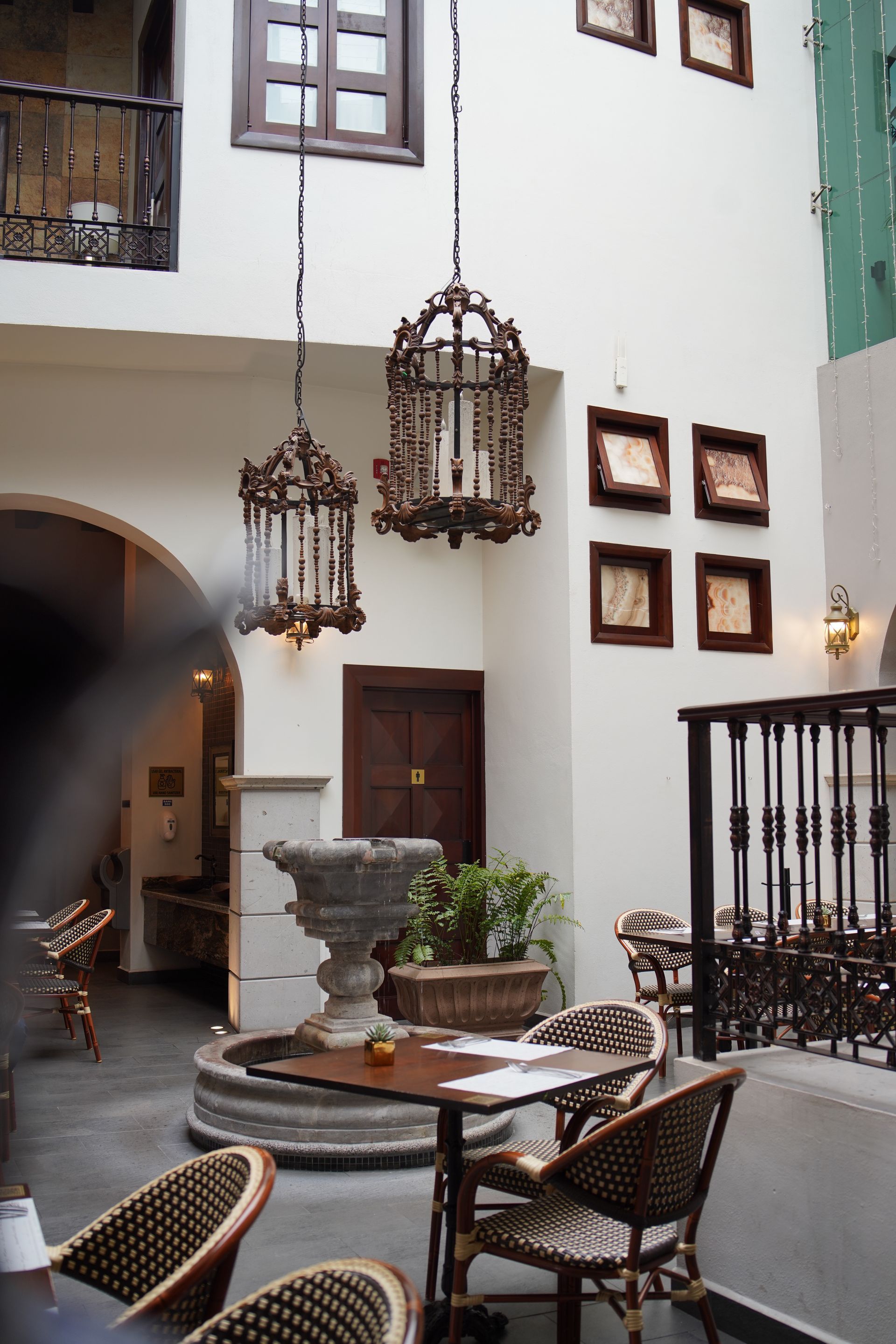 A restaurant with tables and chairs and a fountain