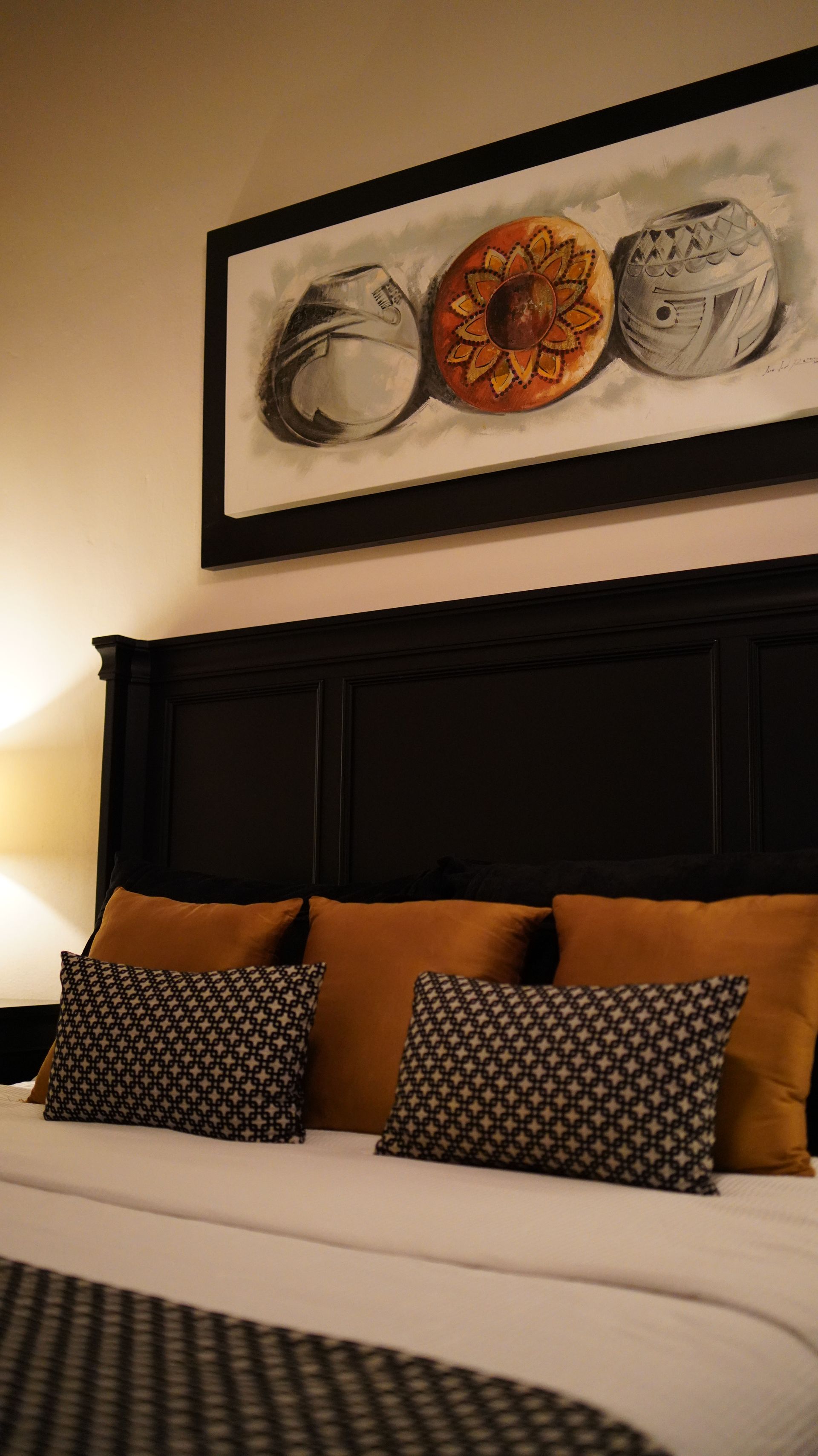 There is a picture of donuts on the wall above the bed.