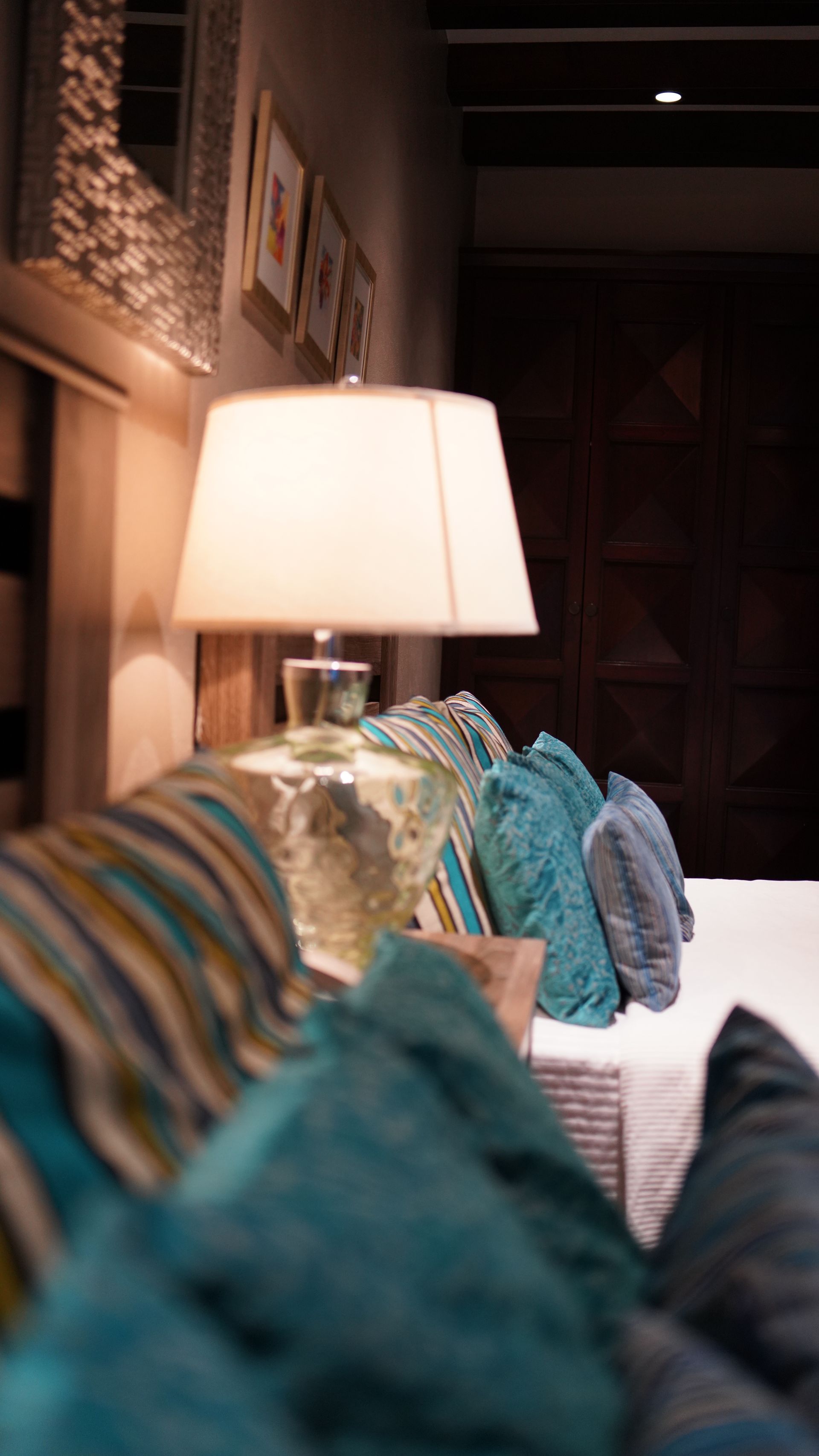 A couch with blue pillows and a lamp in a living room