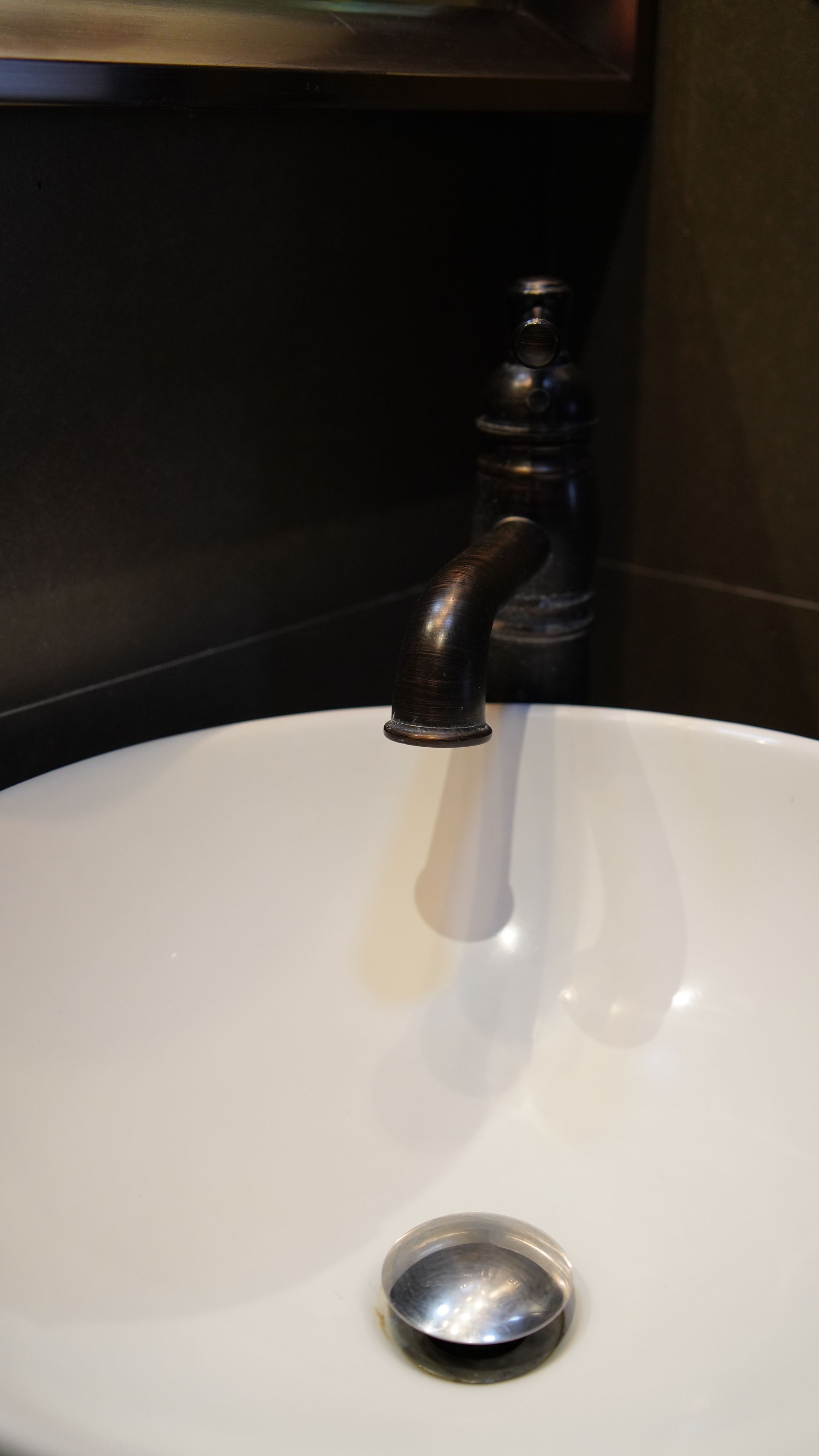 A bathroom sink with a faucet and a drain
