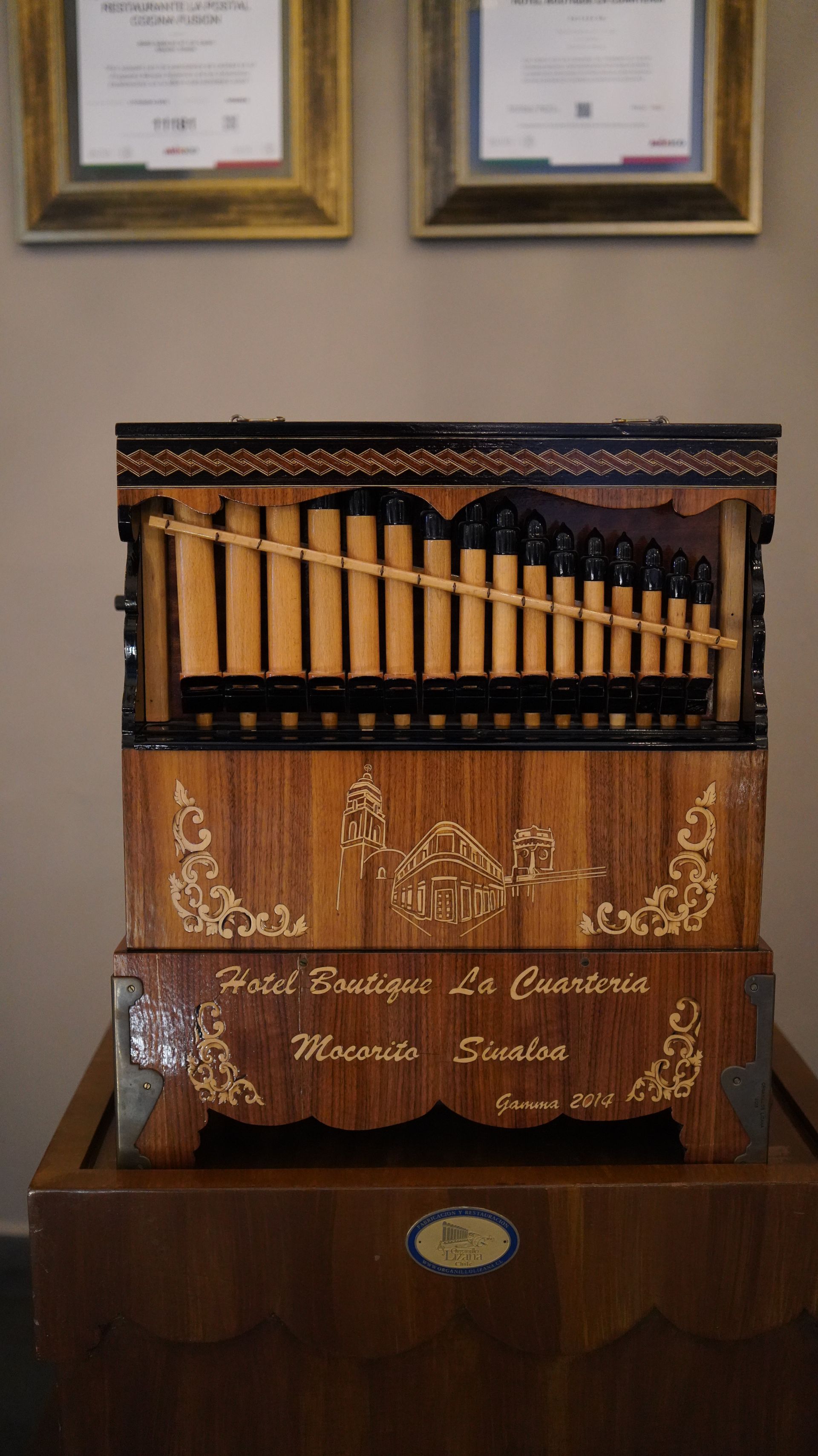 A wooden organ is sitting on top of a wooden table.