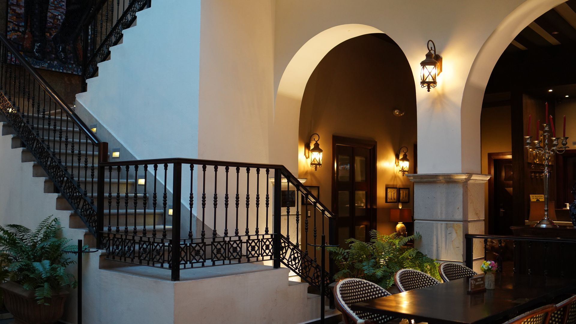 A staircase with a railing and a table in front of it