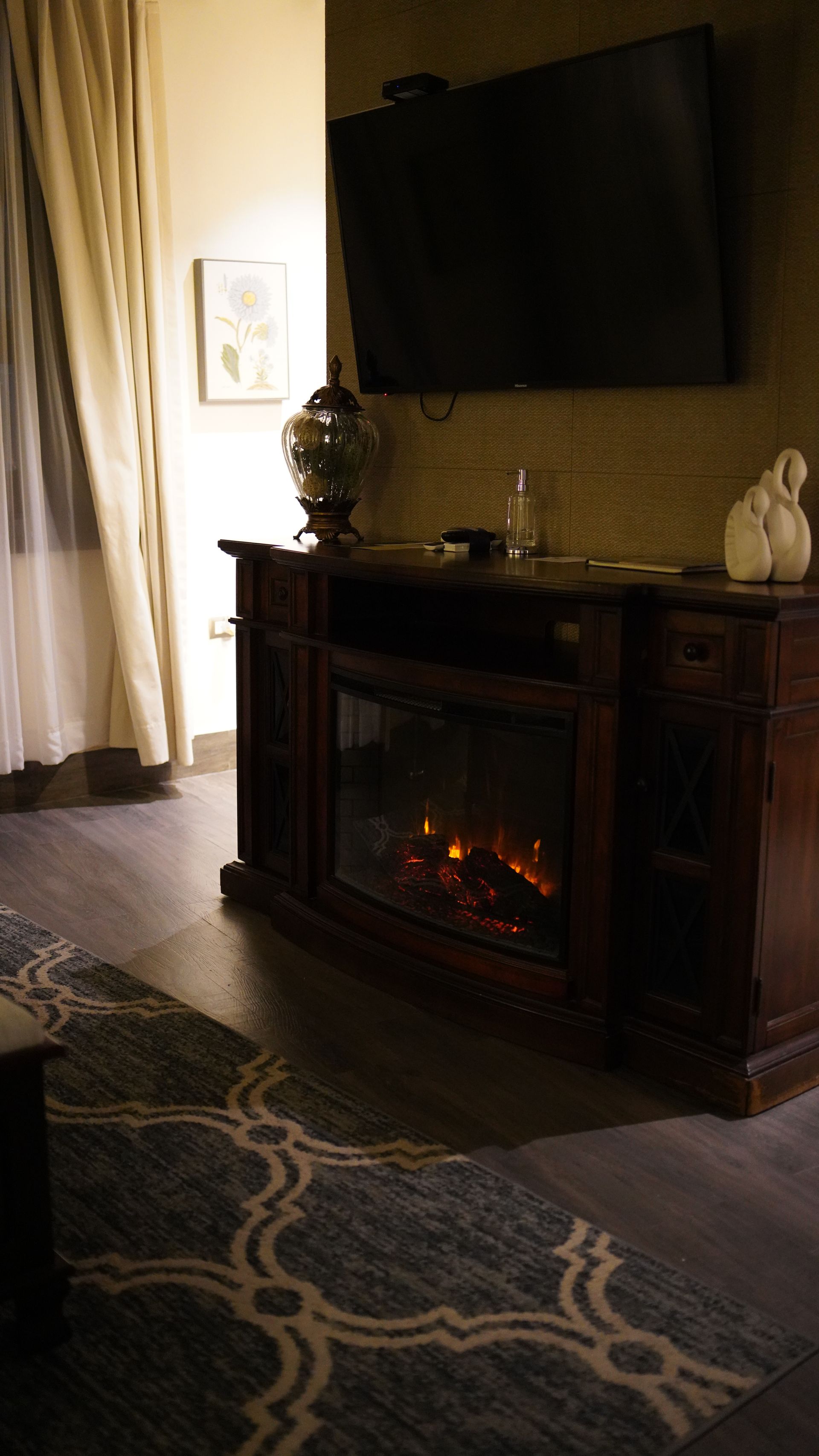 A living room with a fireplace and a flat screen tv.
