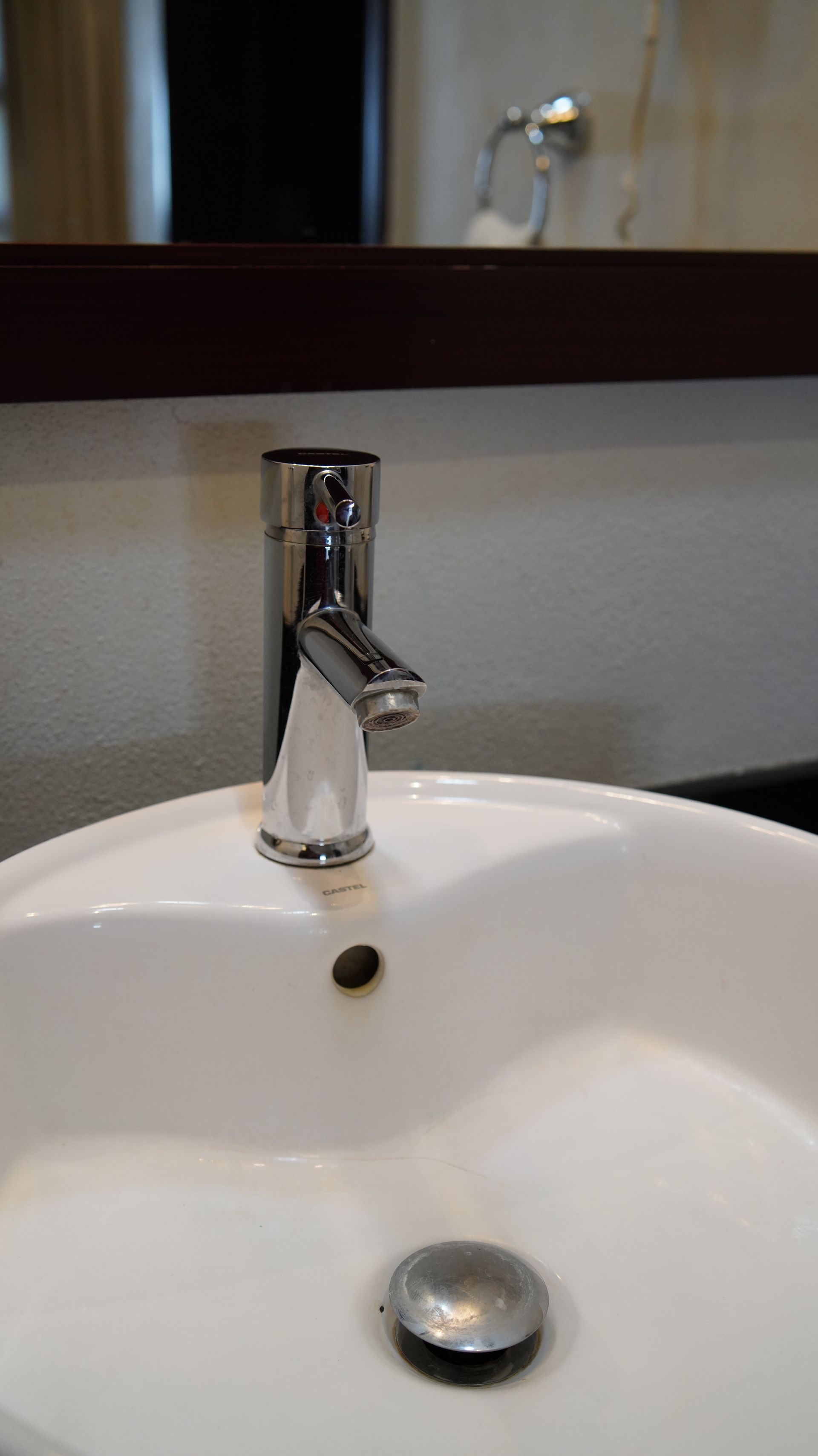 A bathroom sink with a faucet and a mirror