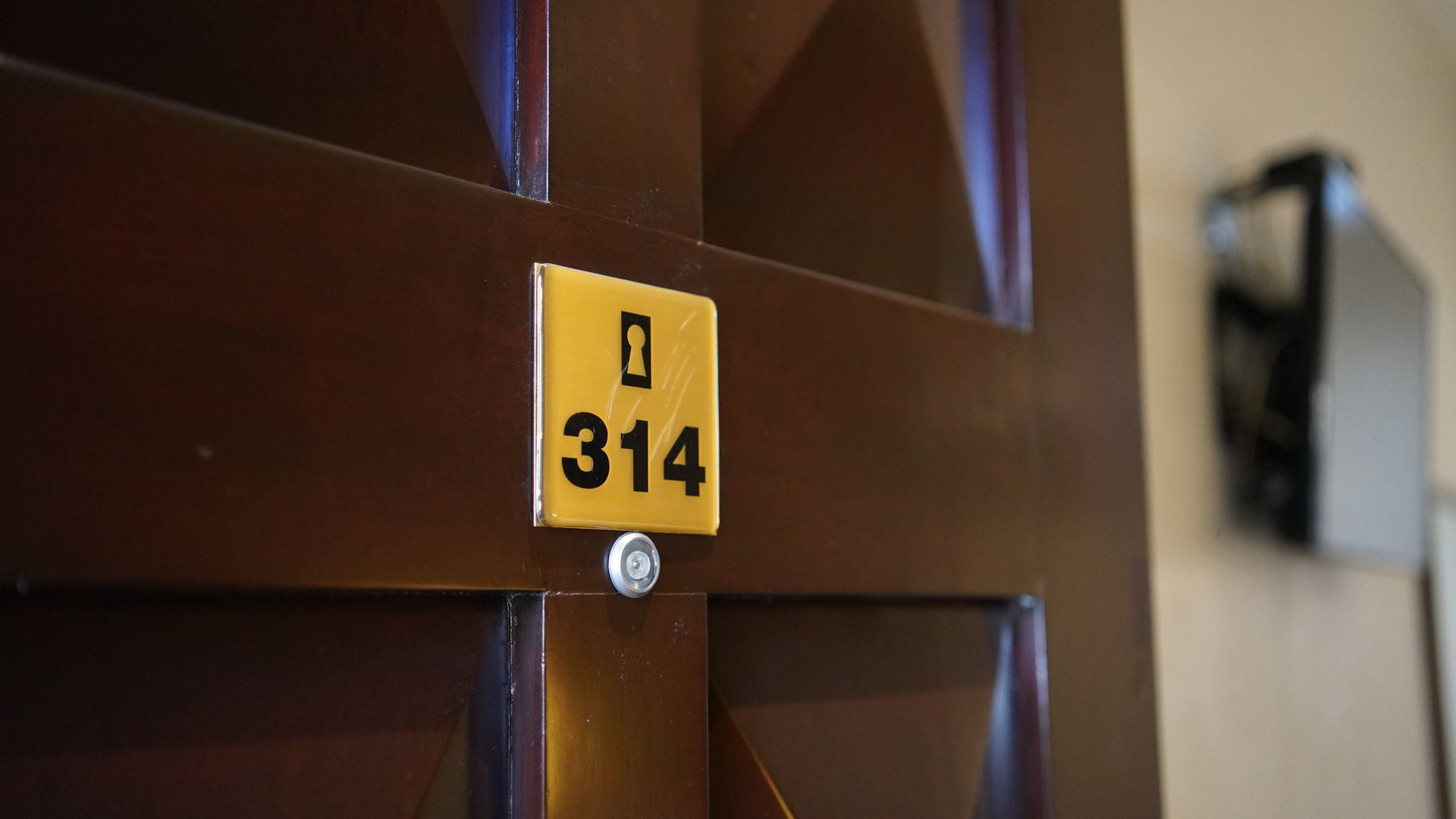 A door with a yellow sign that says 314 on it.