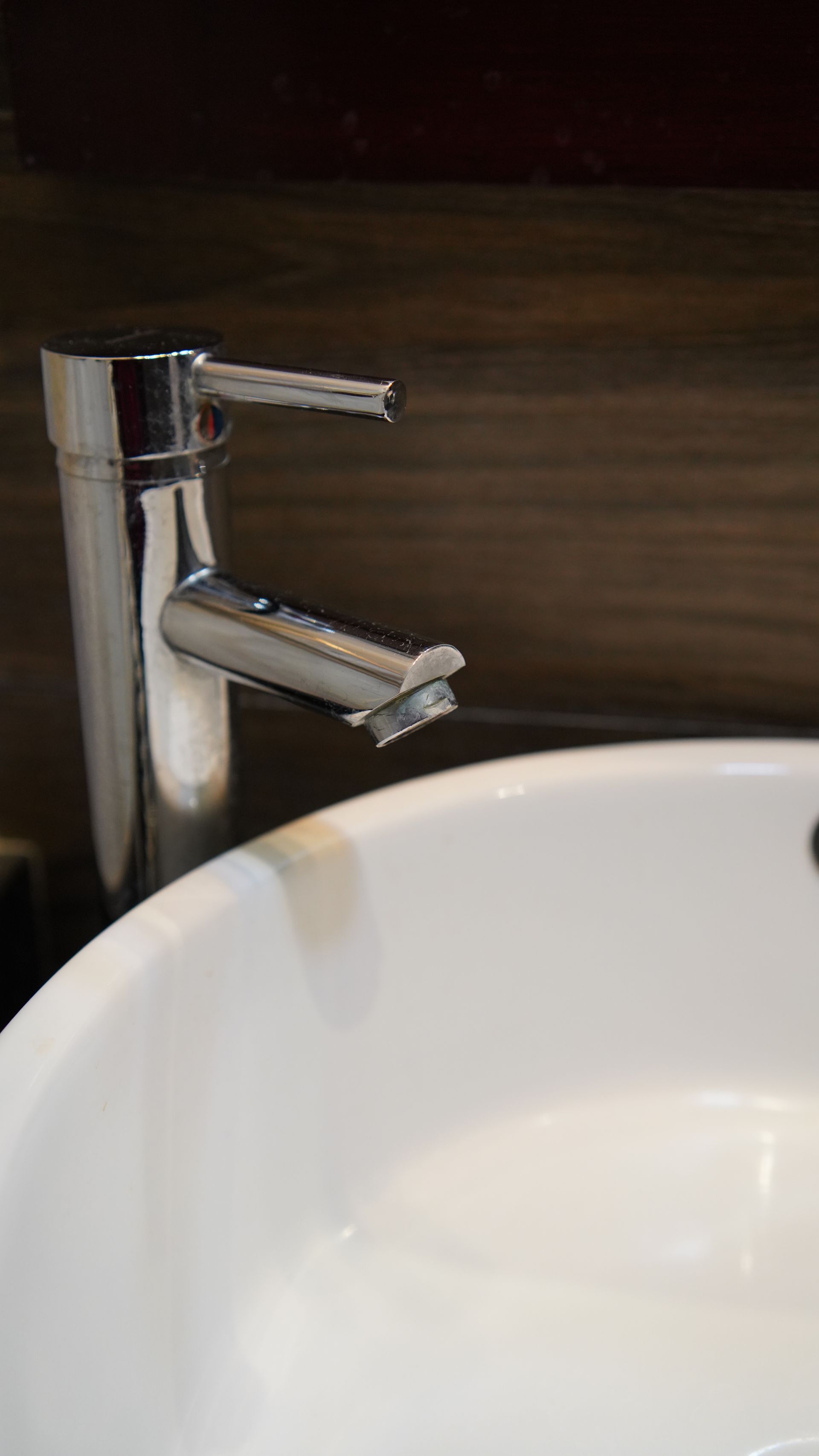 A close up of a bathroom sink with a chrome faucet.