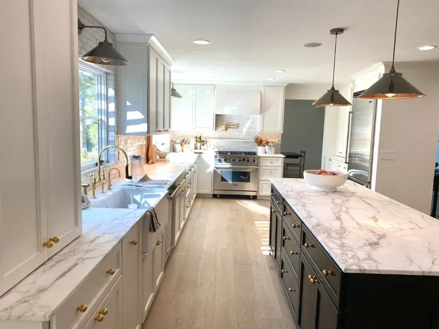 Modern kitchen remodel with marble island and pendant lighting