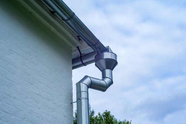 A gutter on the side of a house.