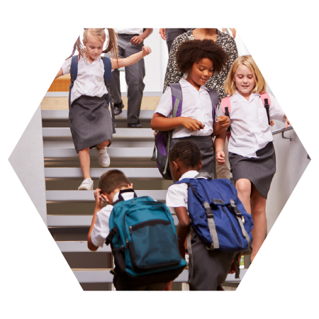 Private school students with backpacks walking down steps together, showing friendship and everyday student life