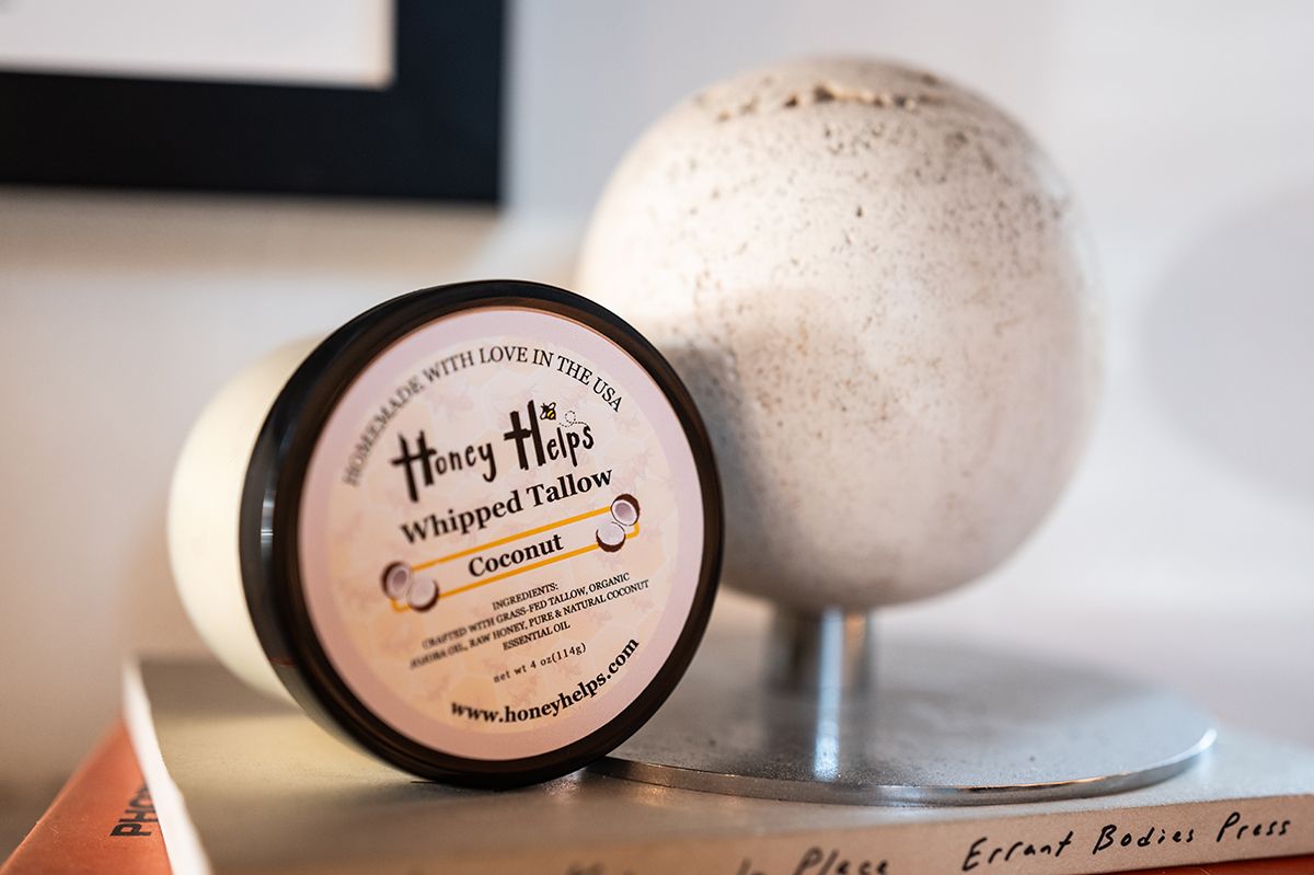 Honey Helps whipped tallow coconut balm jar displayed on a tabletop with minimalist decor