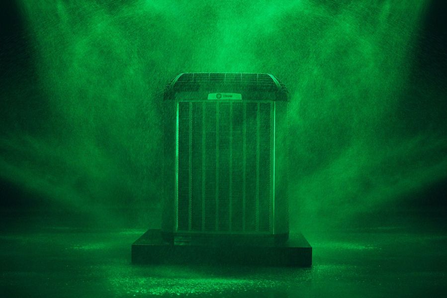 A green box is sitting in a dark room with smoke coming out of it.