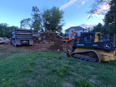 Excavator digging a residential foundation
