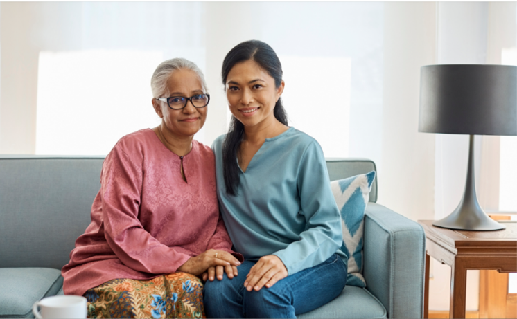 A portrait of a mother and her daughter seated in a living room, after working with a lawyer. A portrait of a mother and her daughter seated in a living room, after working with a lawyer.
