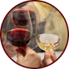 Close-up of hands holding and clinking glasses of red and white wine in a toast.