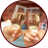 Two hands hold up fluted glasses of champagne to make a toast.