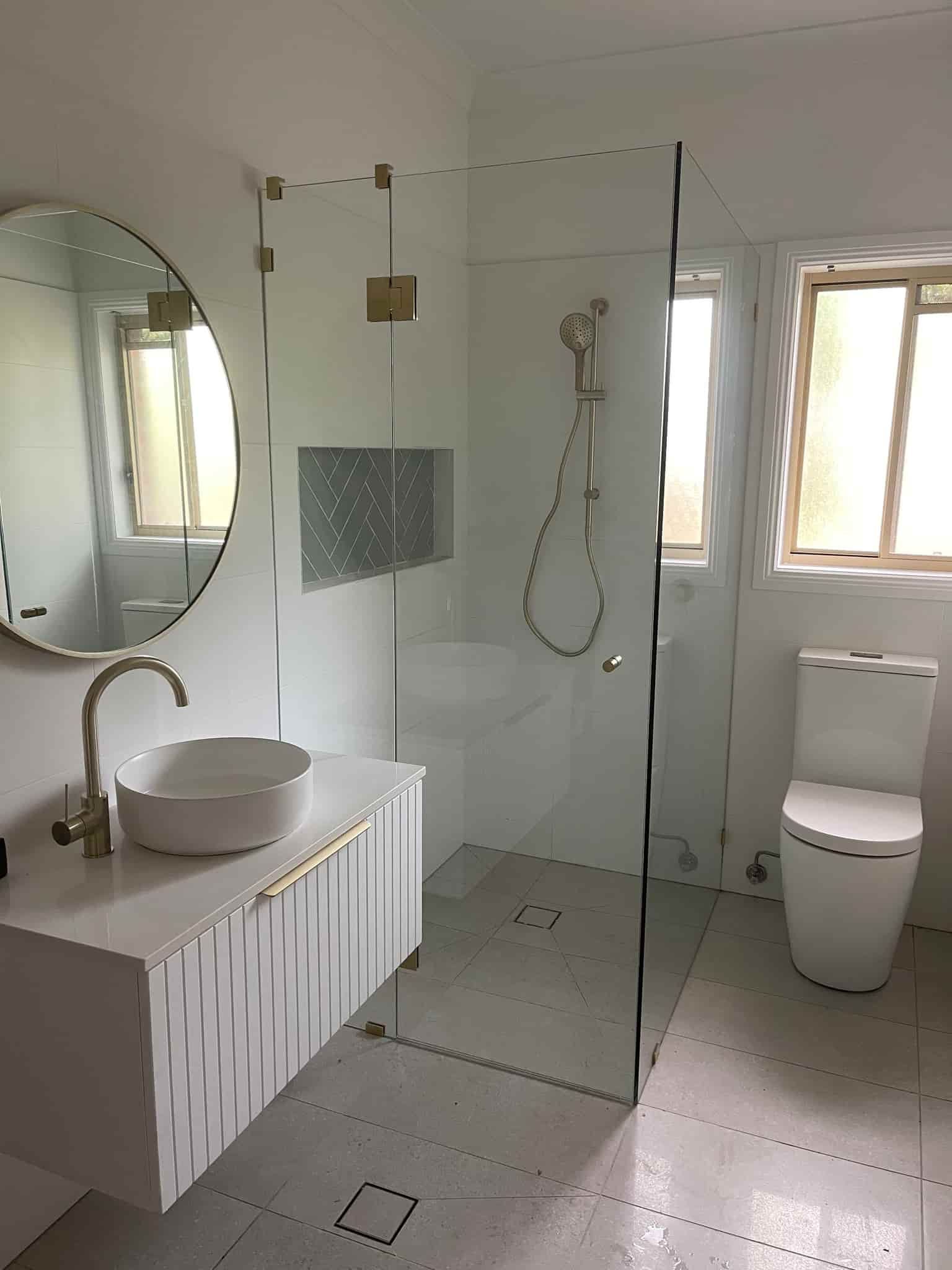 A Bathroom With a Sink, Toilet, Shower and Mirror — Plumbtek Solutions In Mudgeeraba, QLD