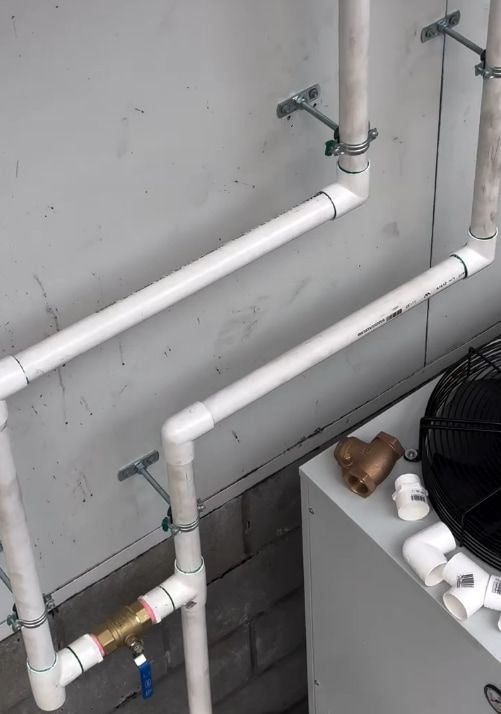 A Bunch of White Pipes Are Connected to a Fan — Plumbtek Solutions In Mudgeeraba, QLD