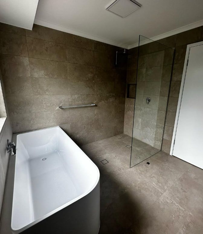 A Bathroom With a Bathtub and a Walk in Shower — Plumbtek Solutions In Mudgeeraba, QLD