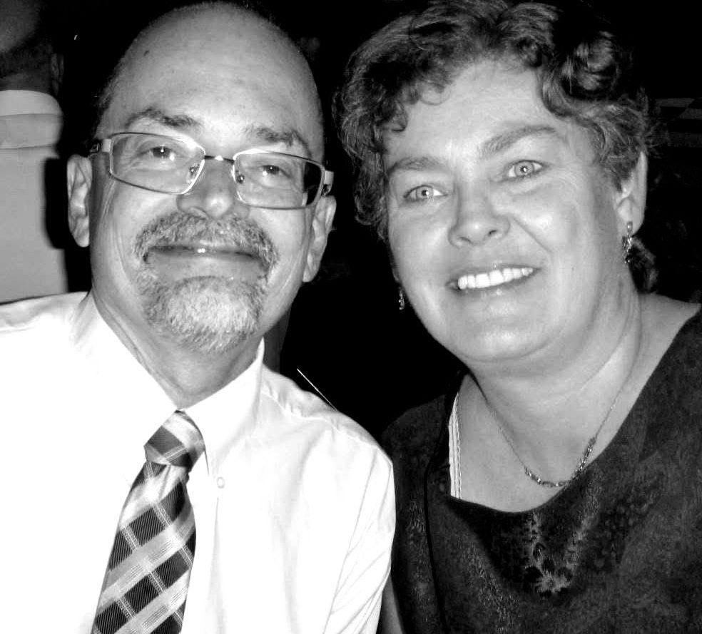 A black and white photo of a man and woman smiling