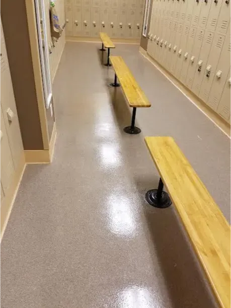A row of wooden benches in a locker room