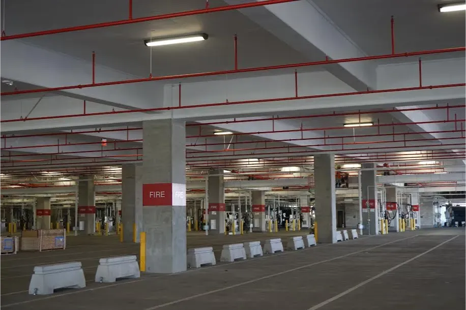 A parking garage with a red sign that says fire