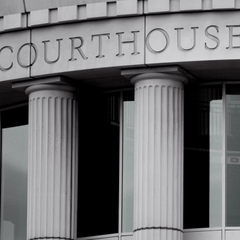 Courthouse entrance with fluted columns and the word