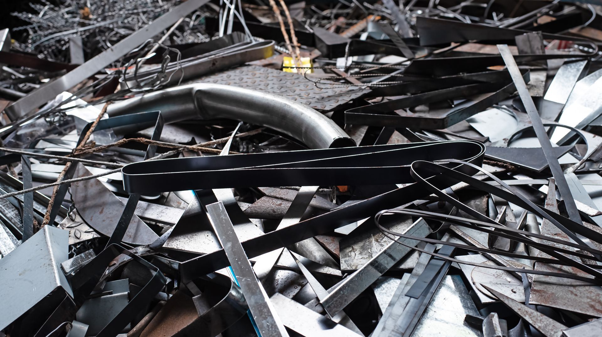 Assorted metal scrap heap, representing commercial recycling of steel and industrial materials.