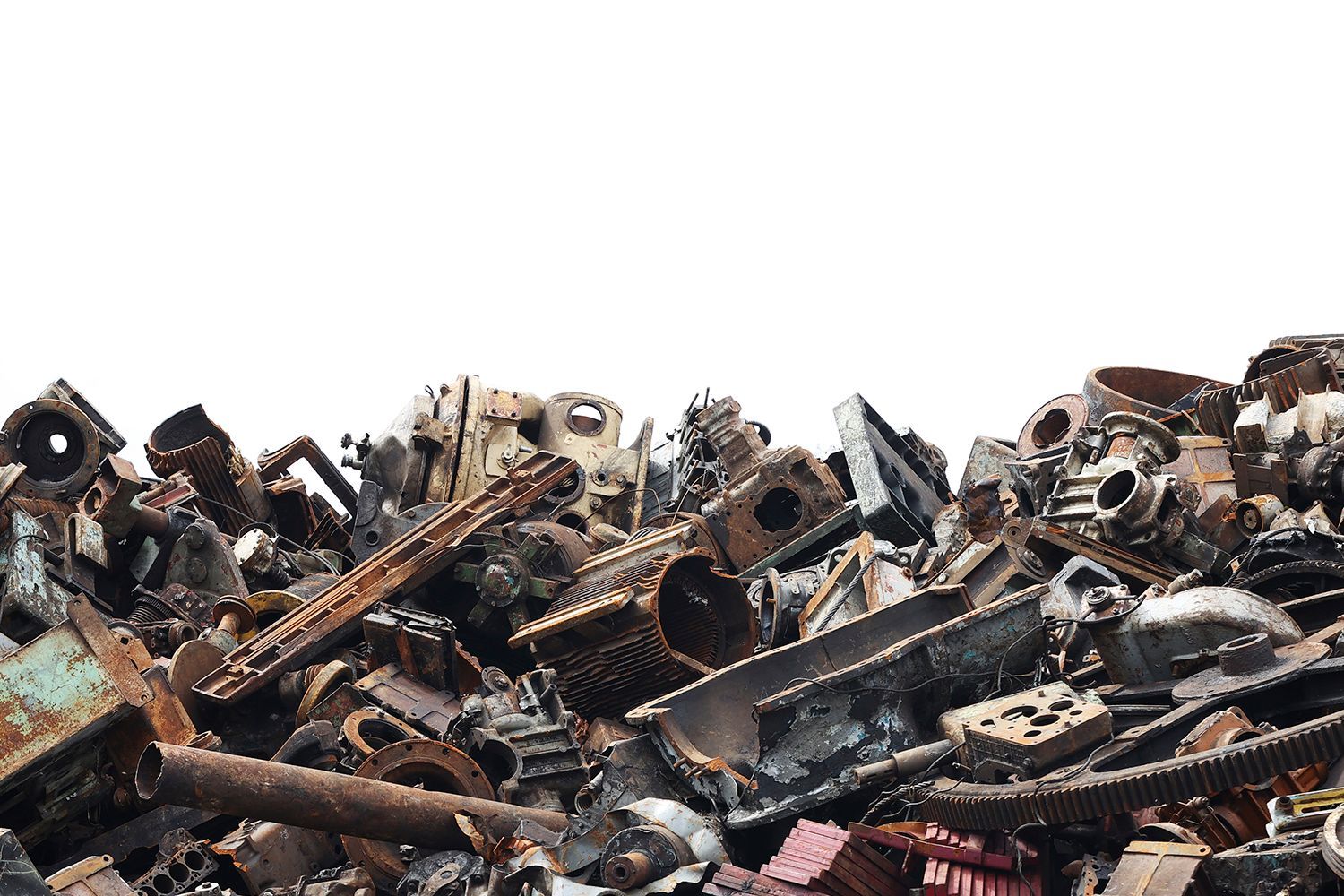 Pile of rusty scrap metal parts and machinery against a white background.