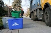 Man Walking Down a Sidewalk Next to a Garbage Truck — Anaheim, CA — Sunwest Metal, INC Man Walking Down a Sidewalk Next to a Garbage Truck — Anaheim, CA — Sunwest Metal, INC