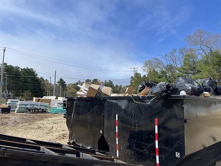 the process of loading a dumpster