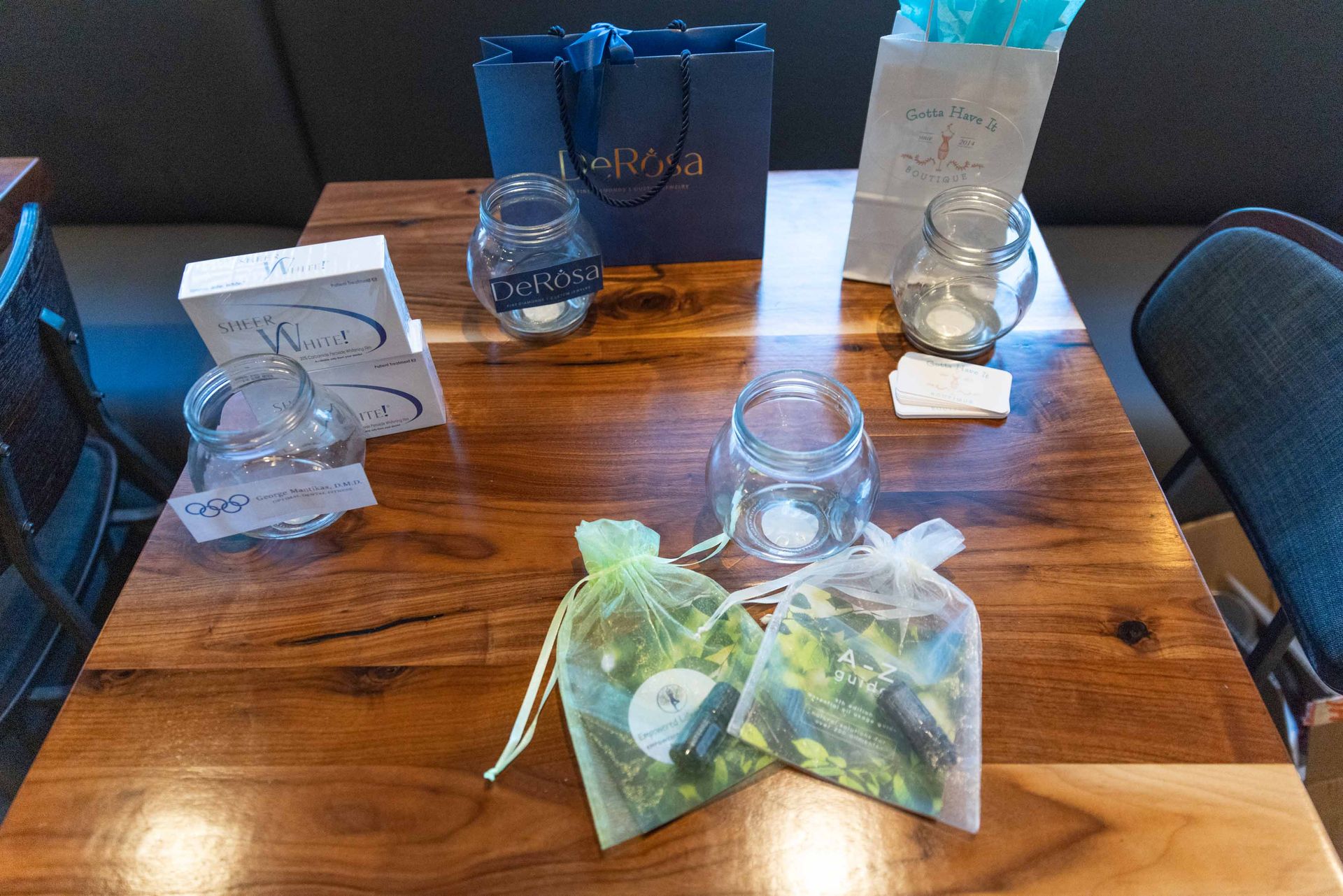 A wooden table with a bag of flowers on it.
