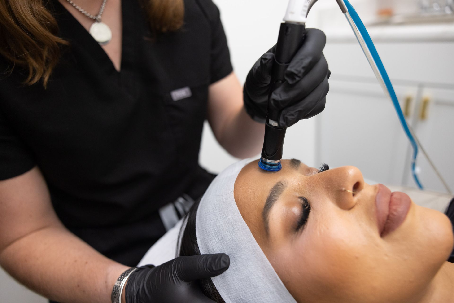A woman is getting a facial treatment at a beauty salon.
