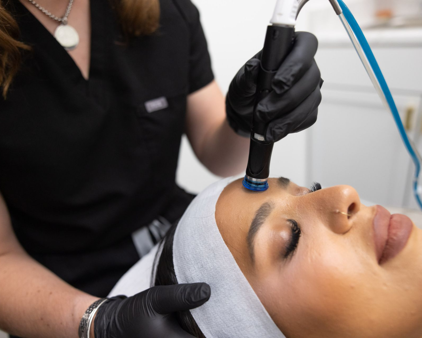 A woman is getting a facial treatment at a beauty salon.