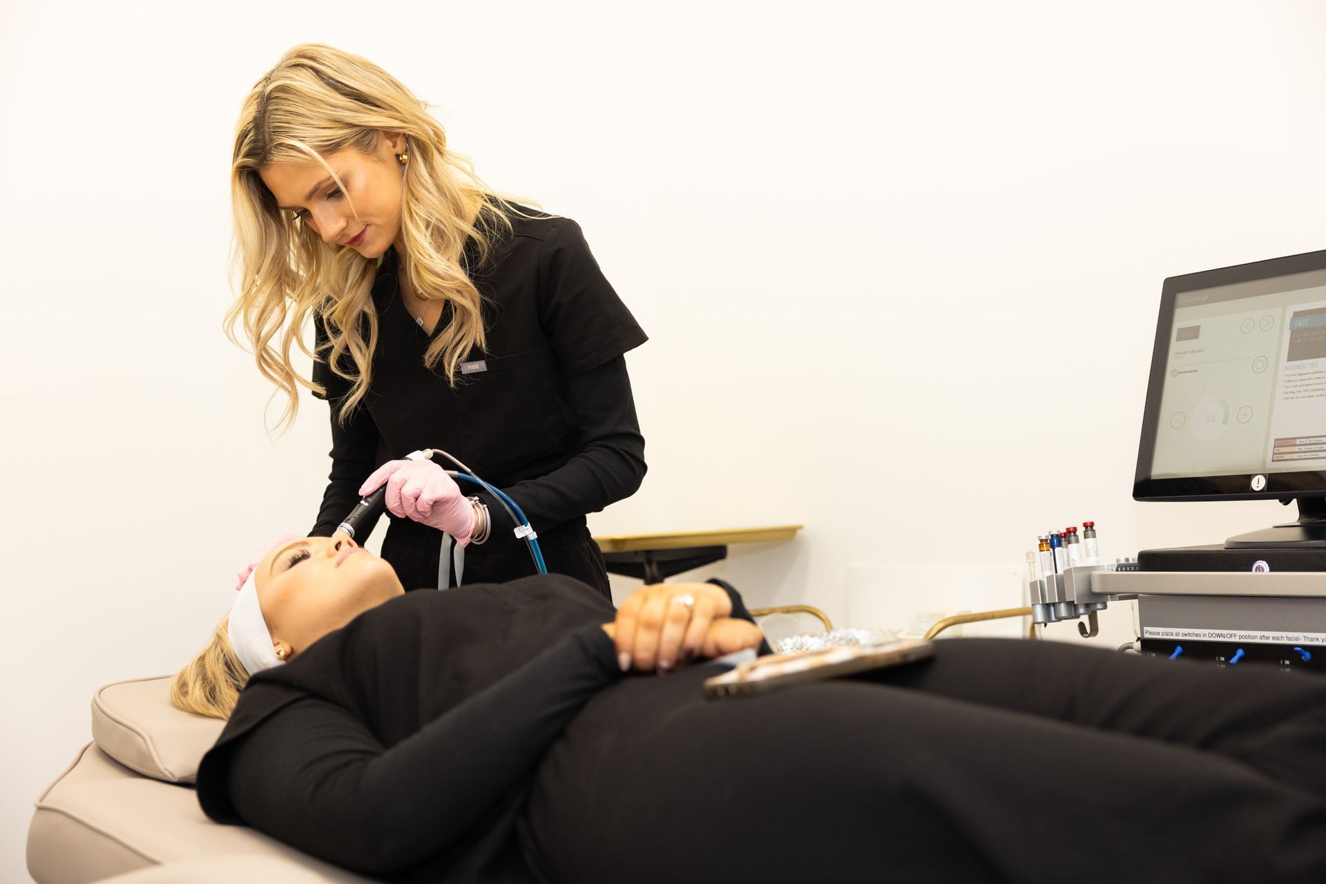 A woman is getting a laser hair removal treatment on her leg.