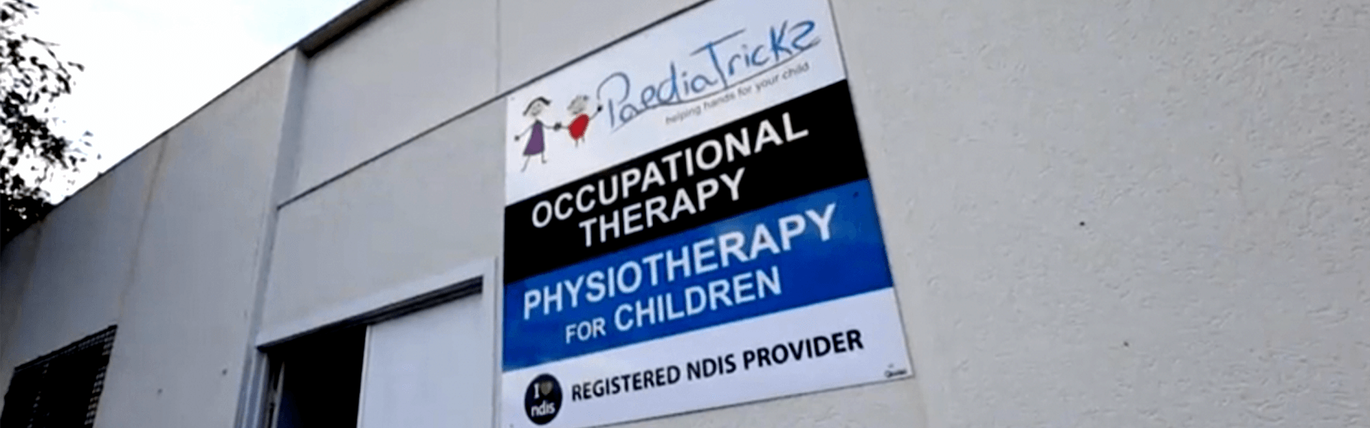 Sign on building advertising occupational, physical, and pediatric therapy services