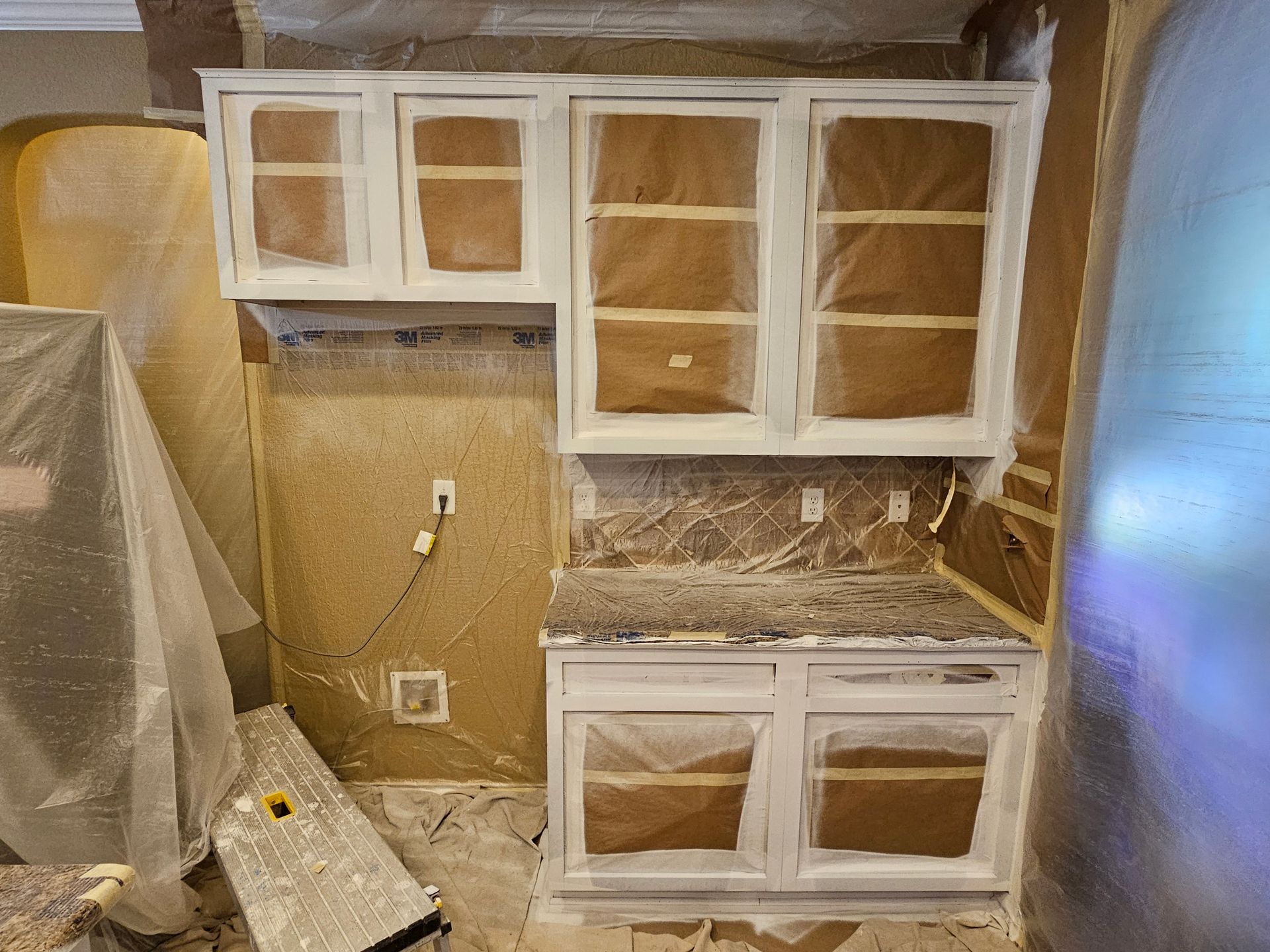 Kitchen cabinets in the process of being refinished.